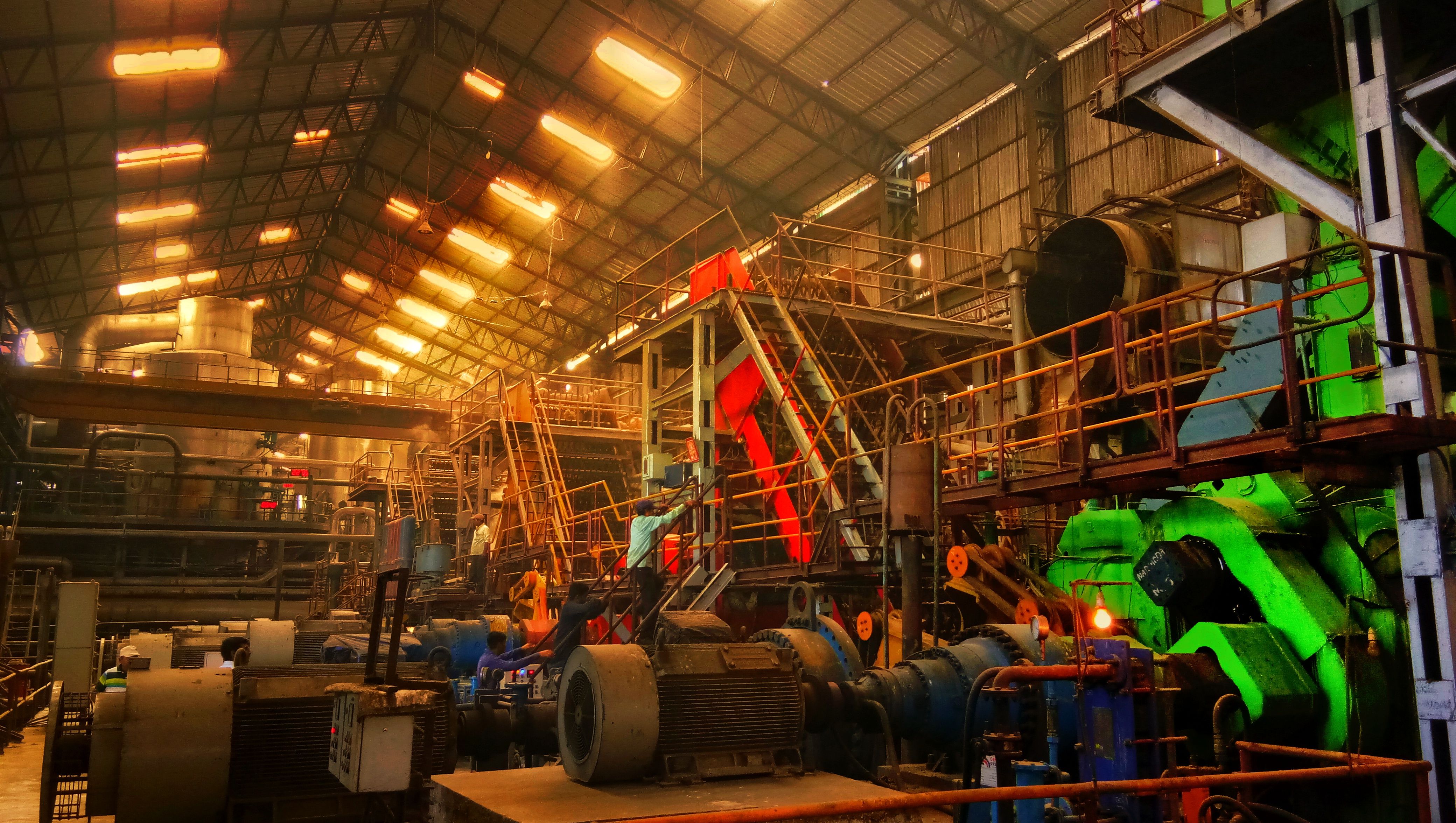 Large-scale industrial machinery and steel structures inside a factory